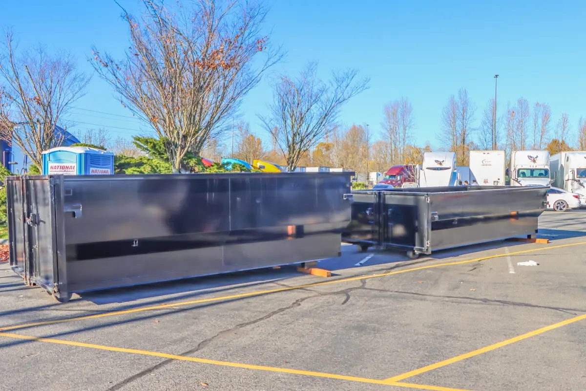 Professional dumpster rental service with roll-off container on residential driveway in Stallings